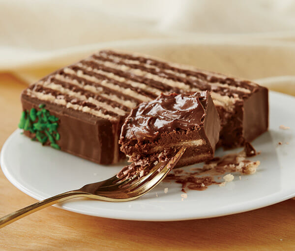 Single Piece of Chocolate Torte Cake on a Plate - A Fork hold one bite of the cake