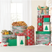 Food gifts in holiday boxes, some open with popcorn, chocolate and candy showing